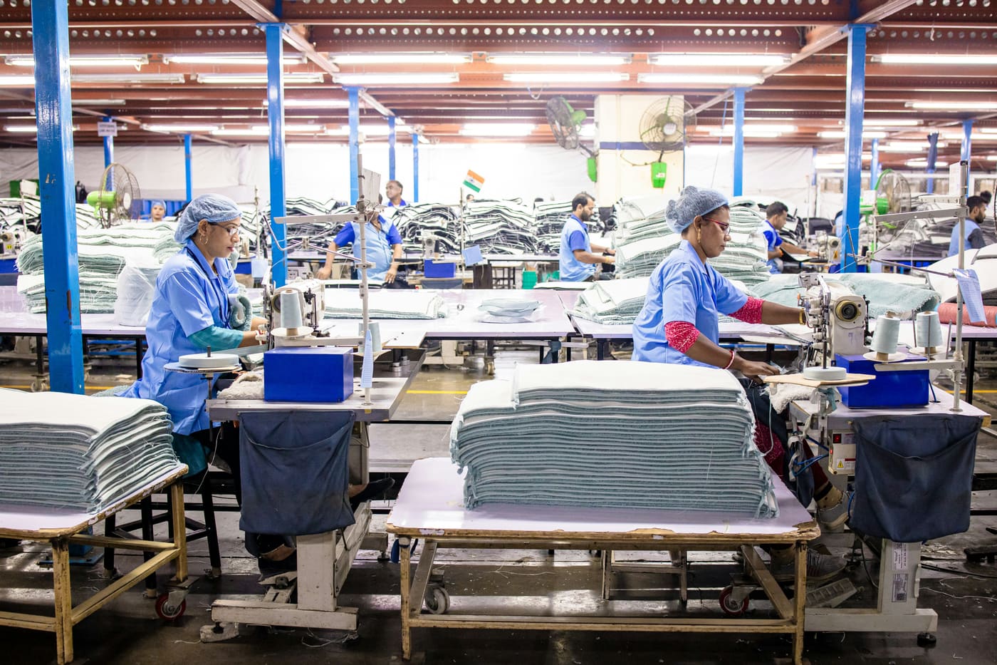 a garment factory floor with workers at sewing tables